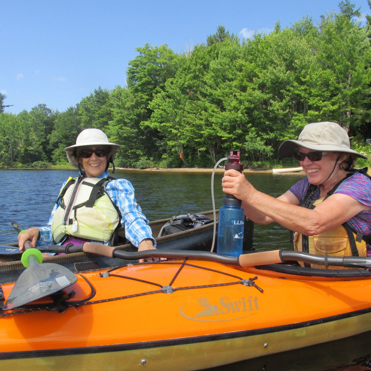 Alison let Peggy try the water filtration device. As Peggy pumped water, she exclaimed, "I want one!"
