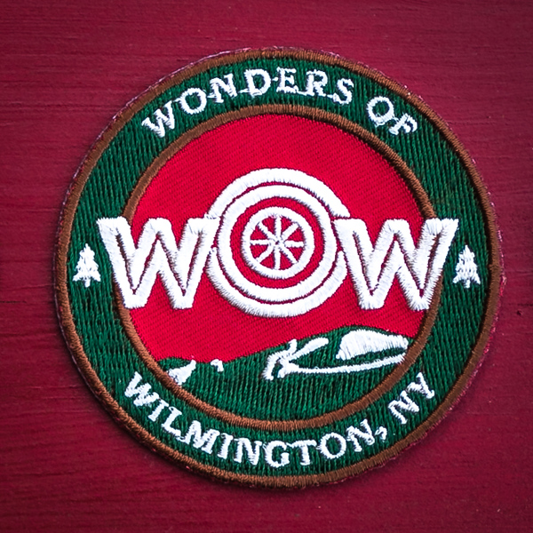 WOW Mountain Biking patch. Red design with bike wheel.