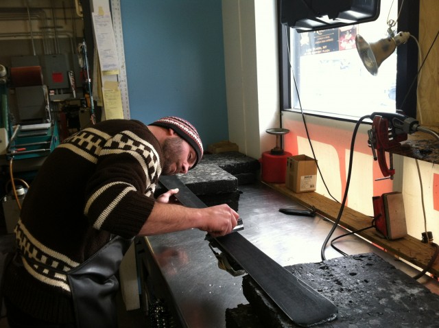 One of Whiteface Mountain's expert Ski Tuner's checks a ski base before edging