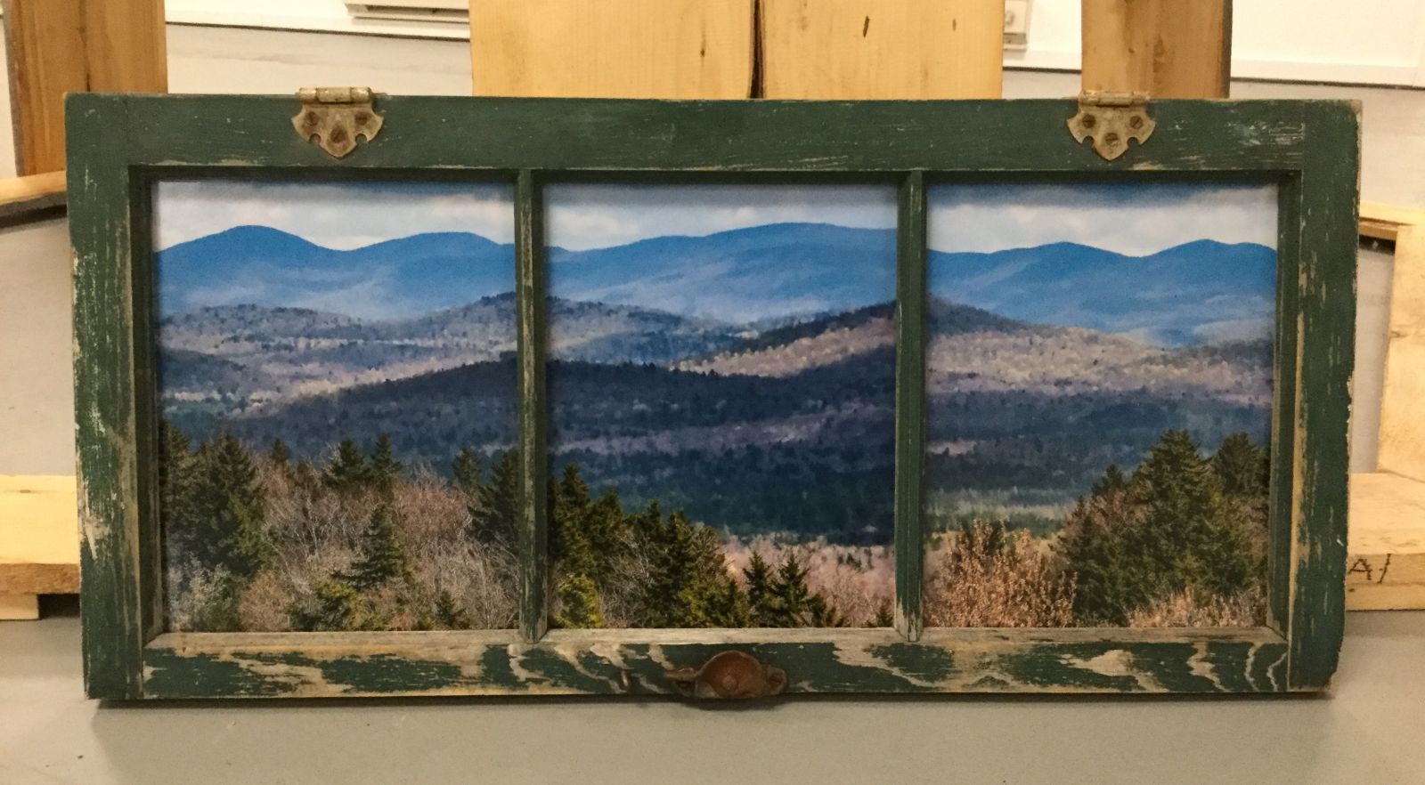 This repurposed window frame creates a perfect setting for the landscape view the artist has created.