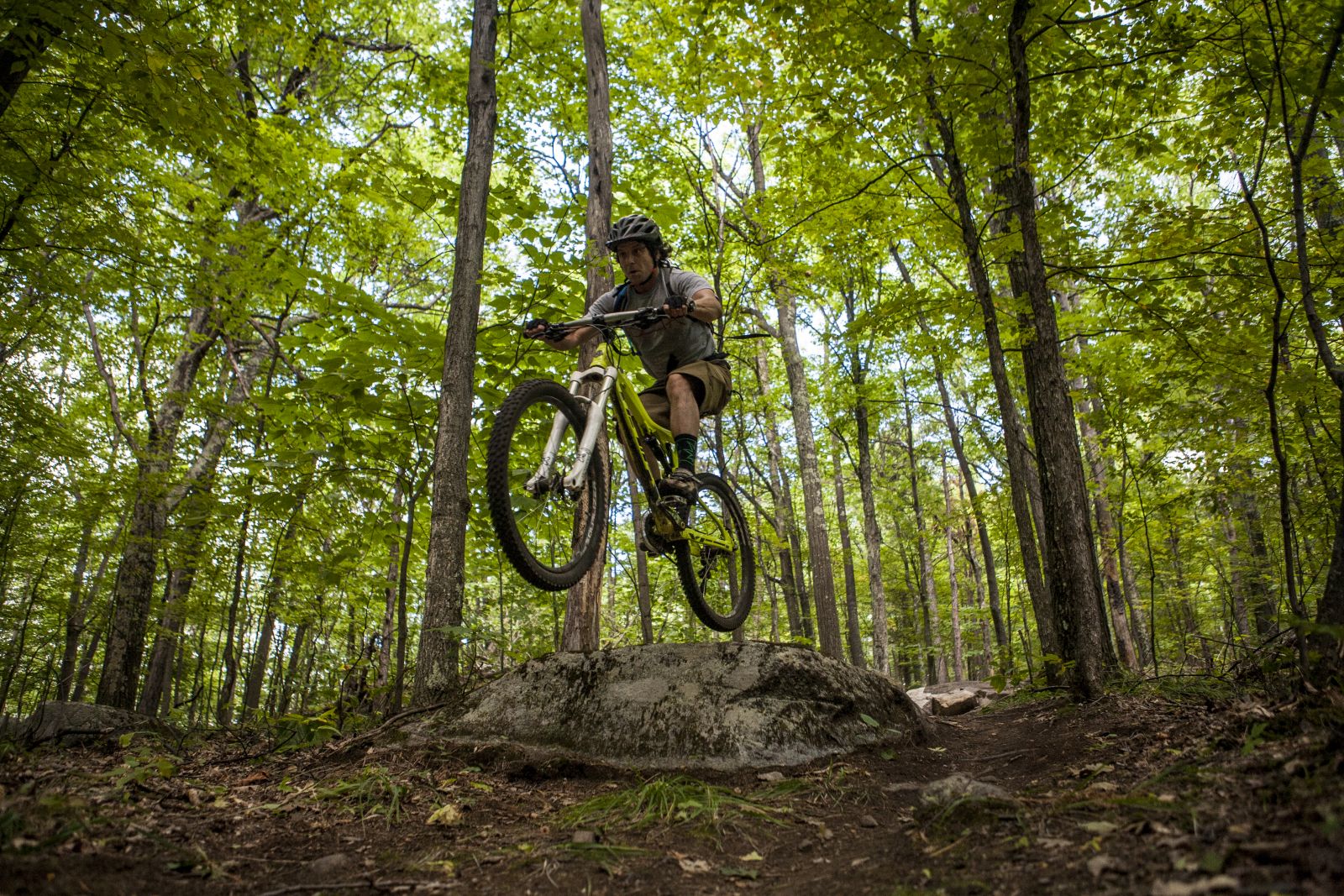 A mountain biker hitting some features on Hardy Road.