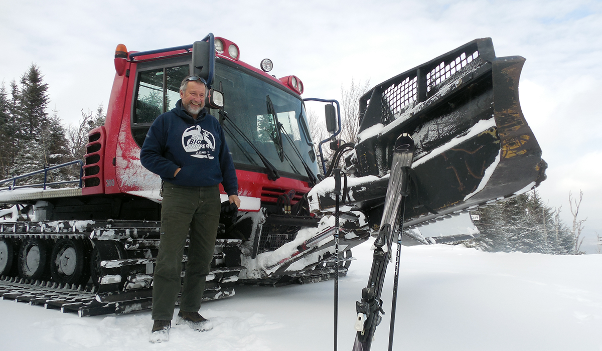 Bill stands in front of Big Tupper's groomer at the top of "Cliff's Cliff"