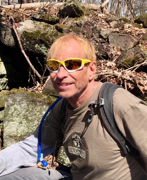 Bill Amadon is trail steward for Champlain Area Trails. Creating trails that are safe, manageable and pass by interesting features is crucial to the job. Here, Bill is sitting amid the ruins of a 19th century farmhouse just off the CATS Homestead Trail.