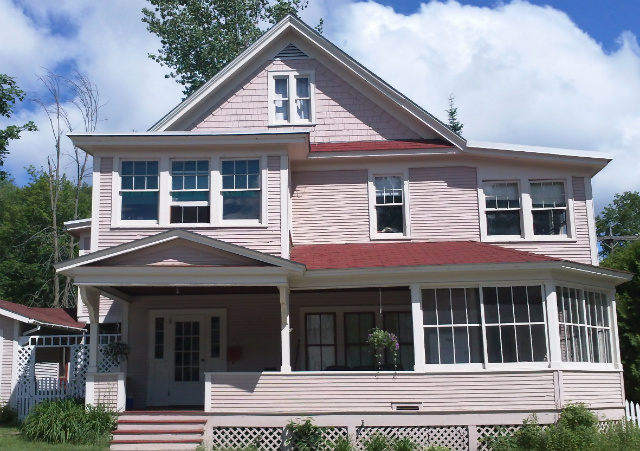 glassed in porches (1st floor, right, 2nd floor, left) held patients taking The Cure A pink home featuring several cure porches that was previously used as one of Saranac Lake's cure cottages
