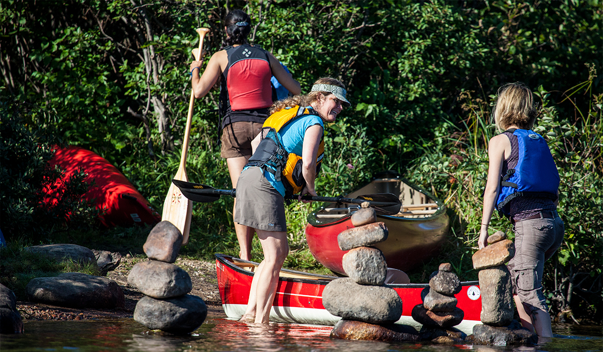 Anne Fleck helps me demo a pack basket canoe at Raquette River Outfitters.