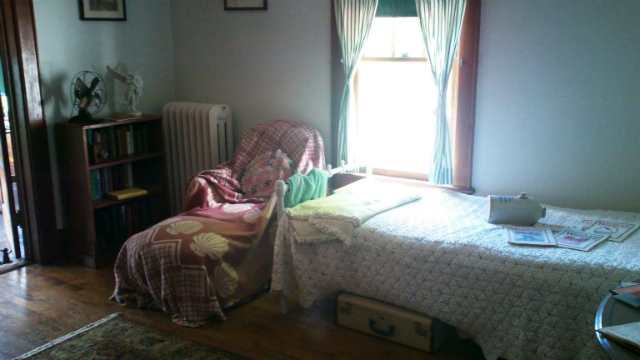 this humble room was where the curing patient would live, perhaps for years The bedroom of one of the cure cottages of Saranac Lake, complete with a bed, recliner, and ceramic jug used to keep feet warm at night known as a "pig"
