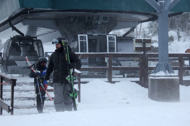 Skiers exit the gondola on the summit of Little Whiteface.