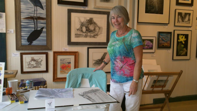 this artist was sketching in the gallery alongside her finished works this artist was sketching in the gallery alongside her finished works