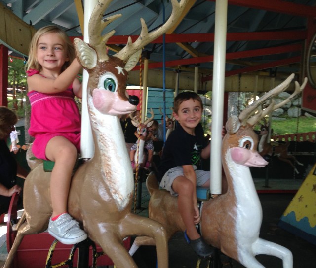 Cousins Julia & Oliver ride matching reindeer - of course.
