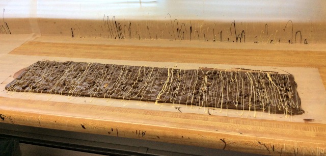 Yes, please! This batch of almond bark is "setting" to keep its shape and decoration sturdy enough to be moved to the cooling room.