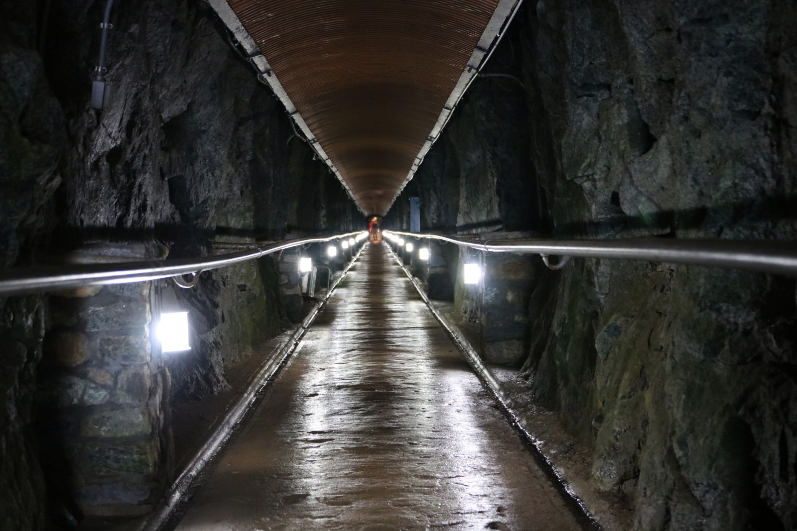 The tunnel is long and well-lit.