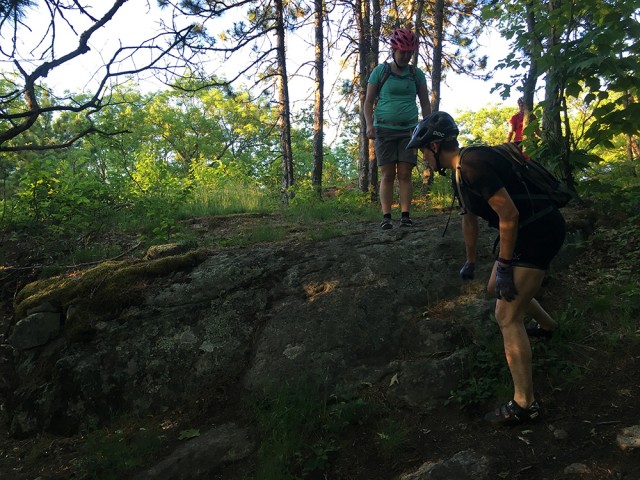 Scoping out a good line to go over the boulder at the top of All In