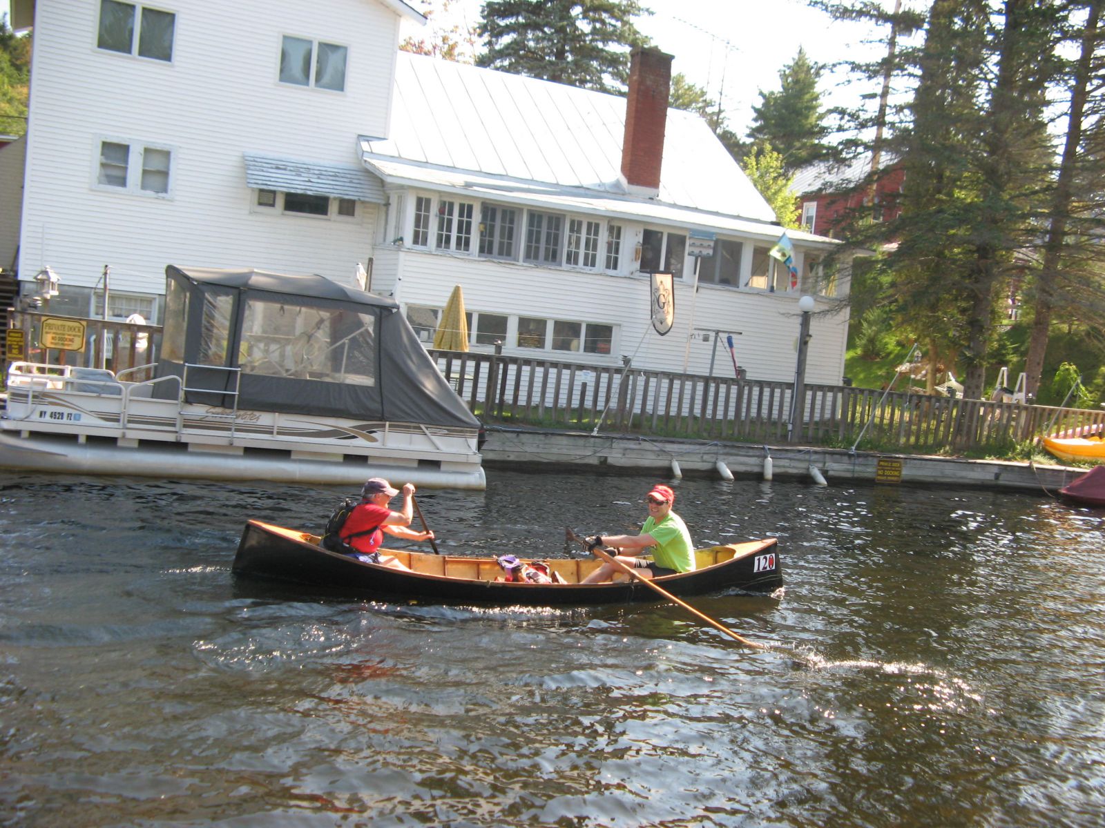 Day 1: The river at Inlet, doubles in a guide boat. Chris Hoyt at the oars, Mary Brown at the paddle.