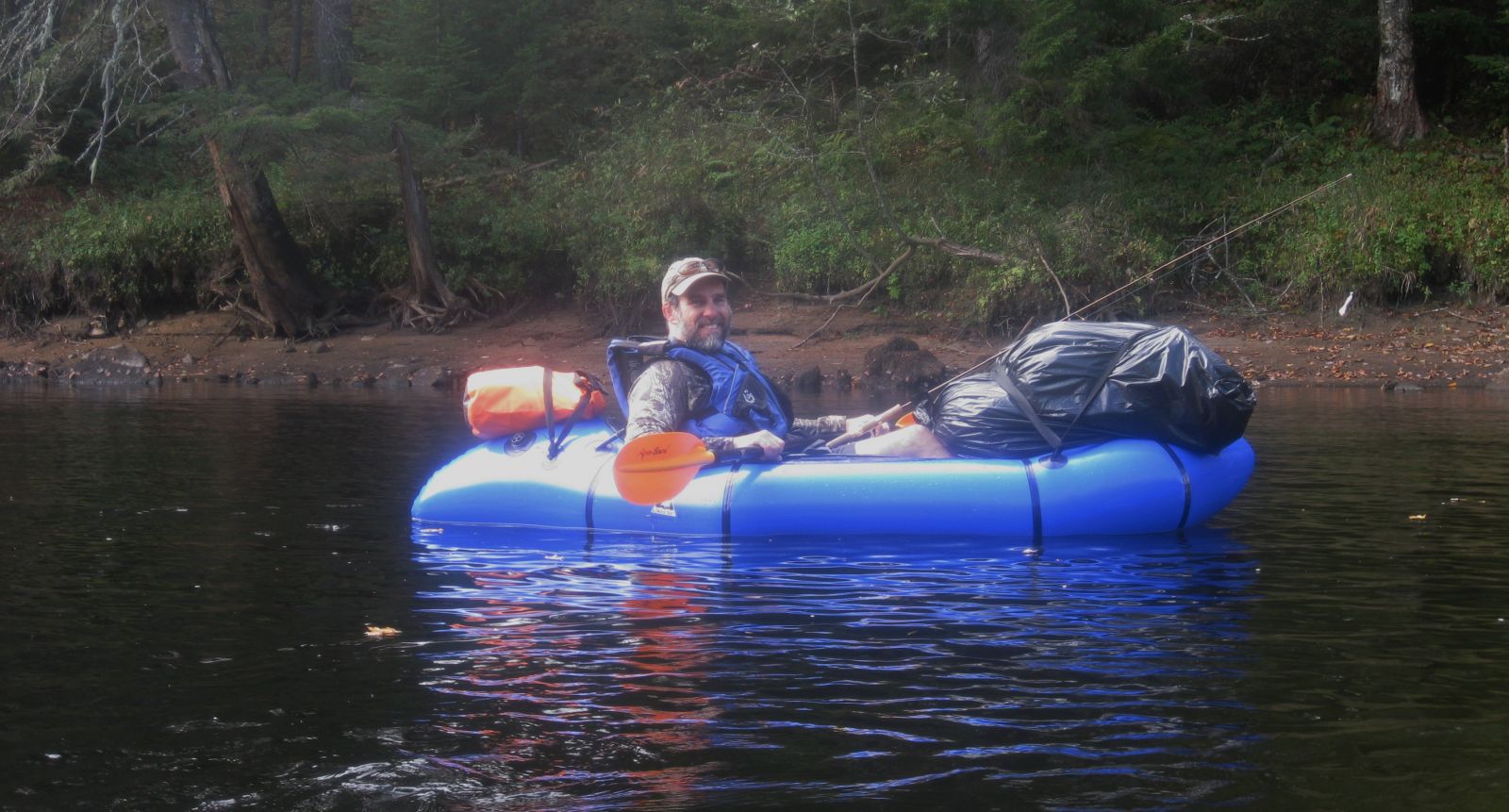 Man from Rhode Island floating and fishing in his blue raft.
