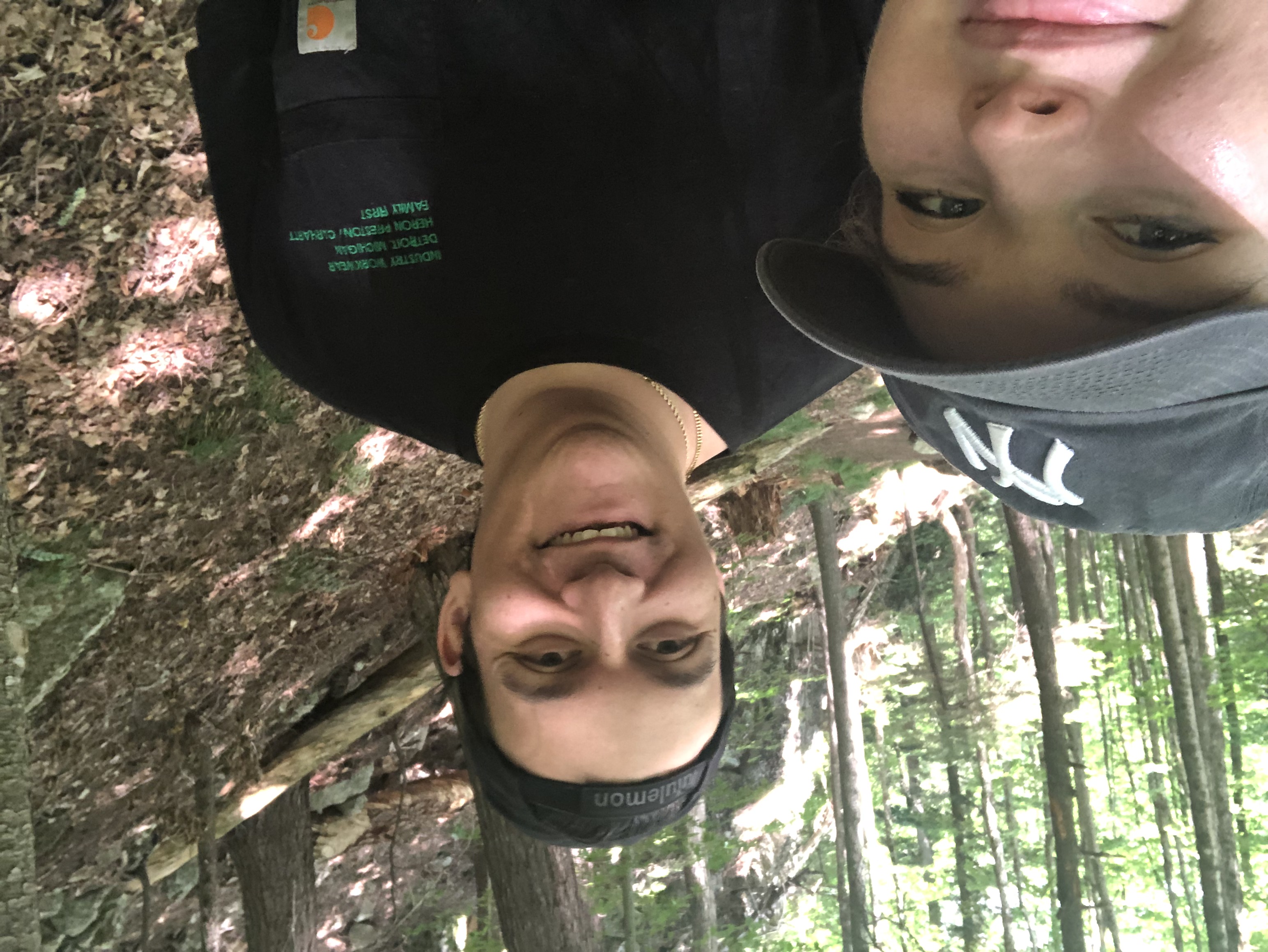 A man and woman take a selfie on a hiking trail