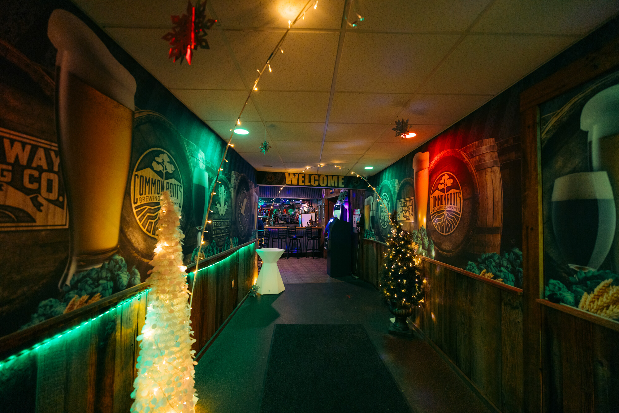 A colorfully lit up entrance to a bar and restaurant