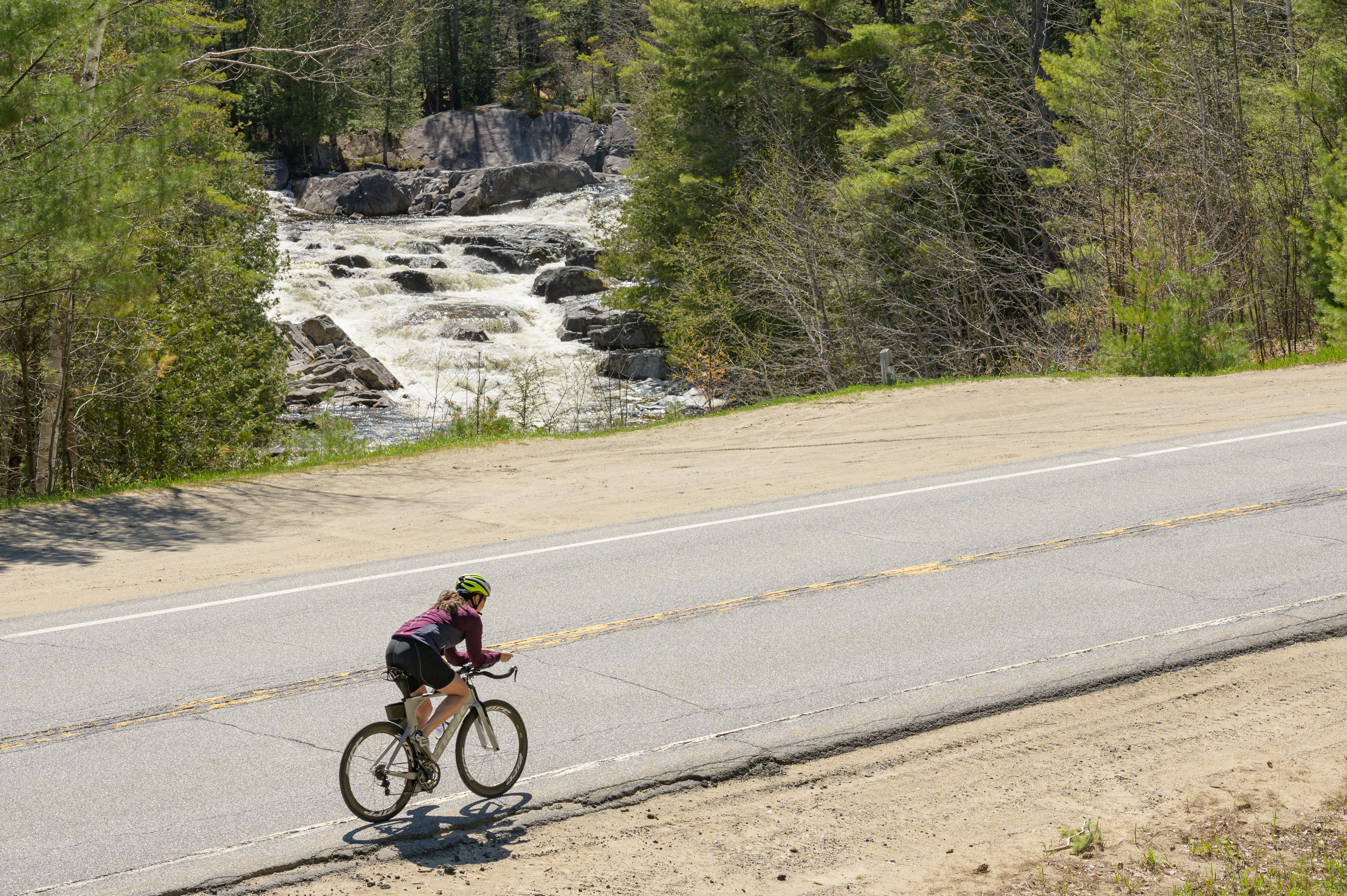 Woman biking in North Hudson across Blue Ridge Falls