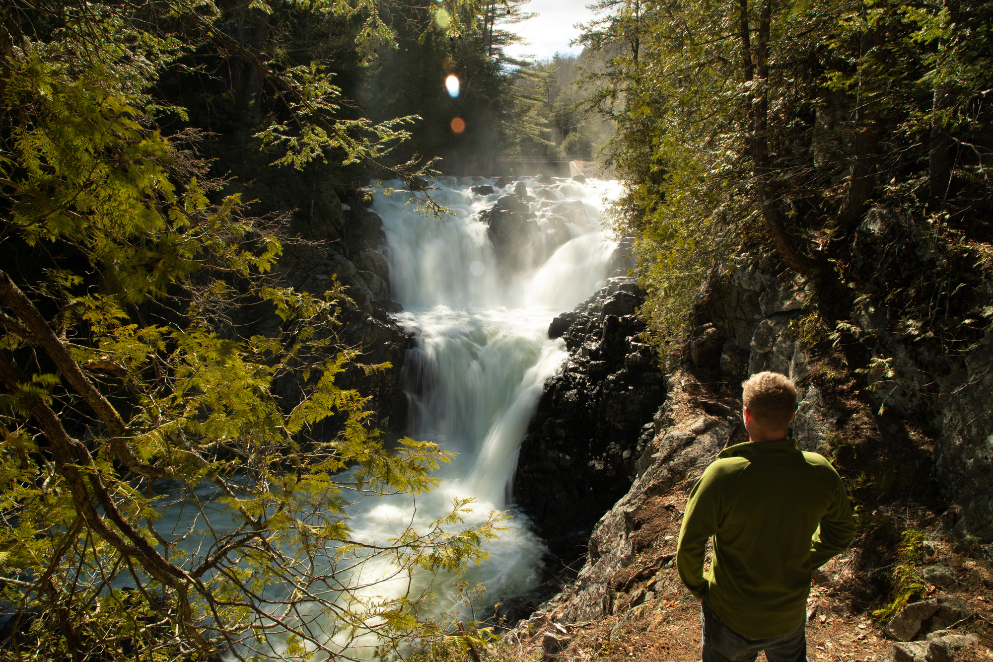 A man in front of Split Rock Falls.
