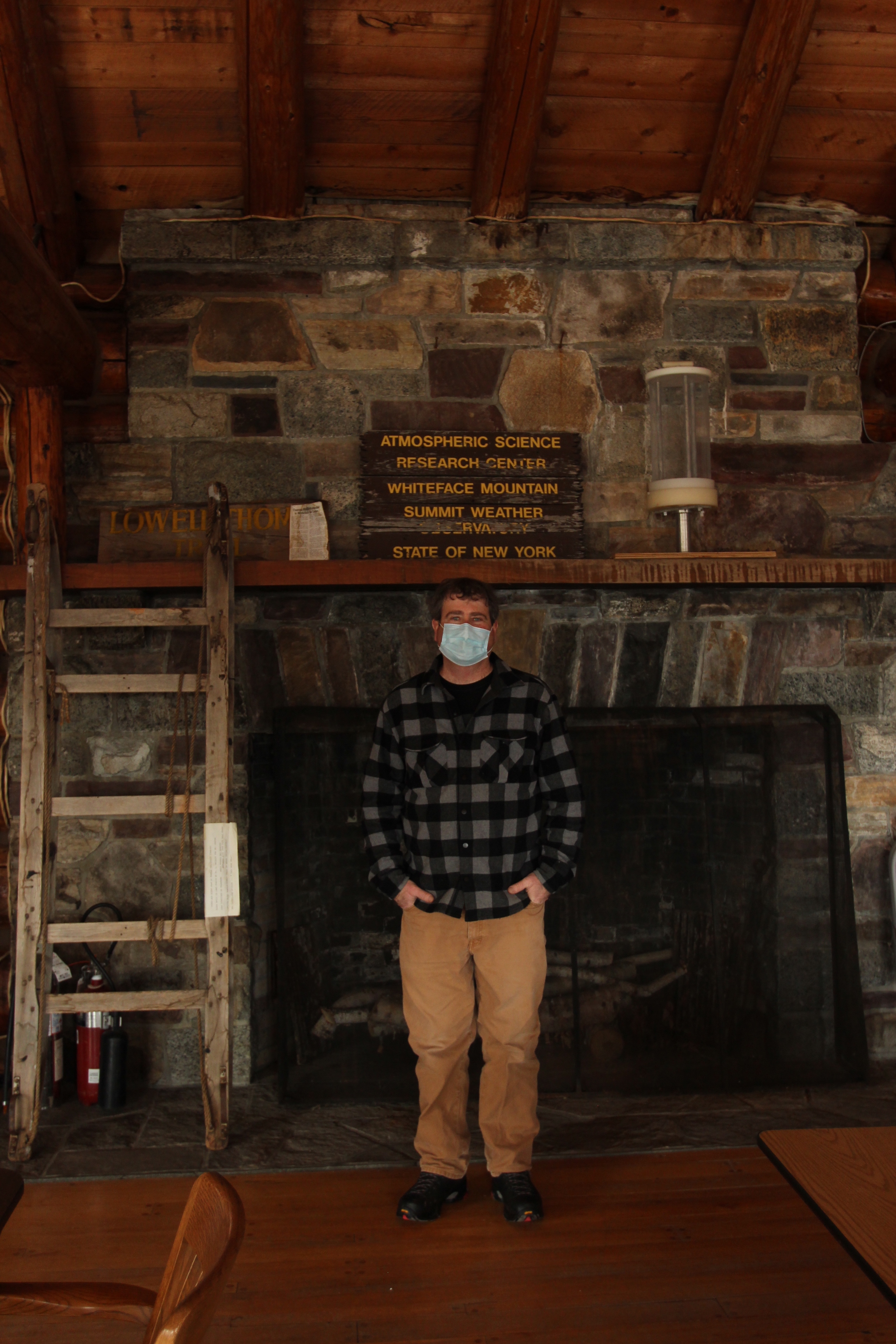 Paul Casson stands in the ASRC lodge. An old cloud collector sits on the mantel to his left.