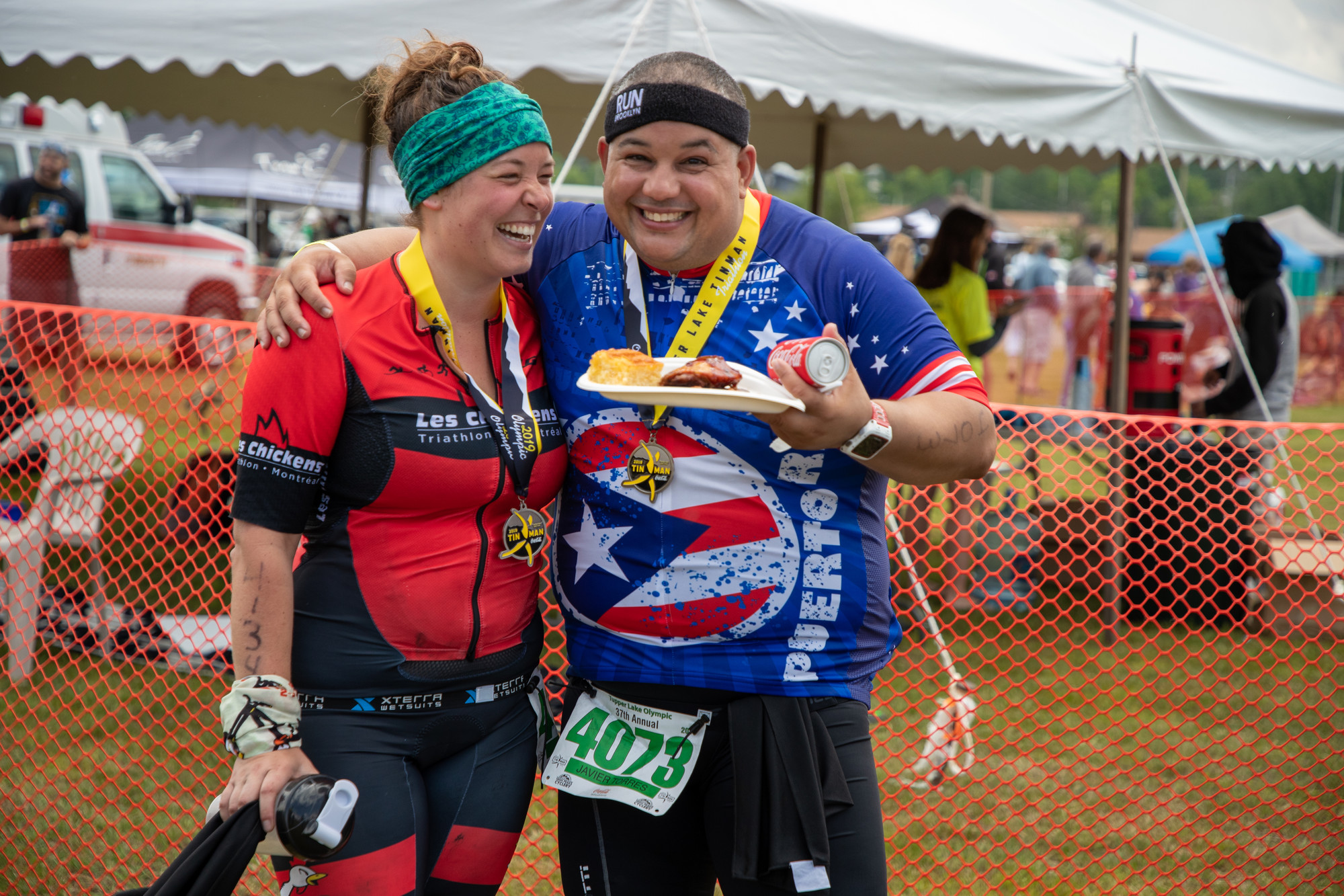 a man and woman laugh at the end of a race.