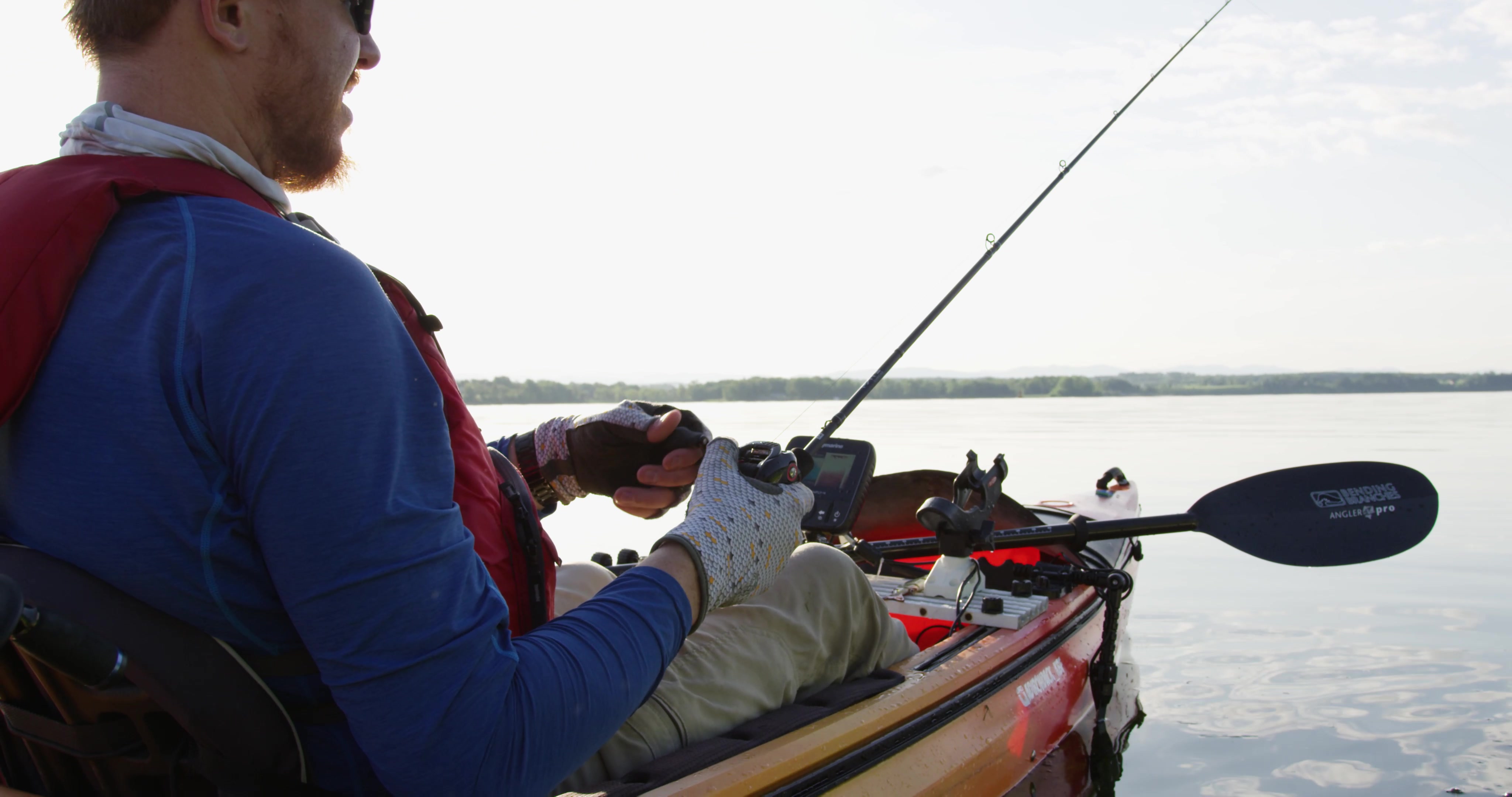 A close up of Brian as he manages his line, fishing for small mouth bass.