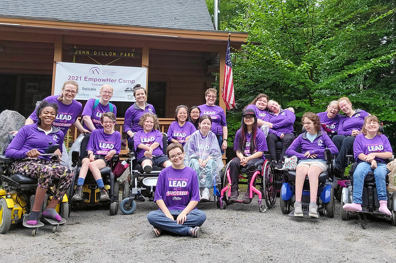 A group of women from a disability rights group at a campground.