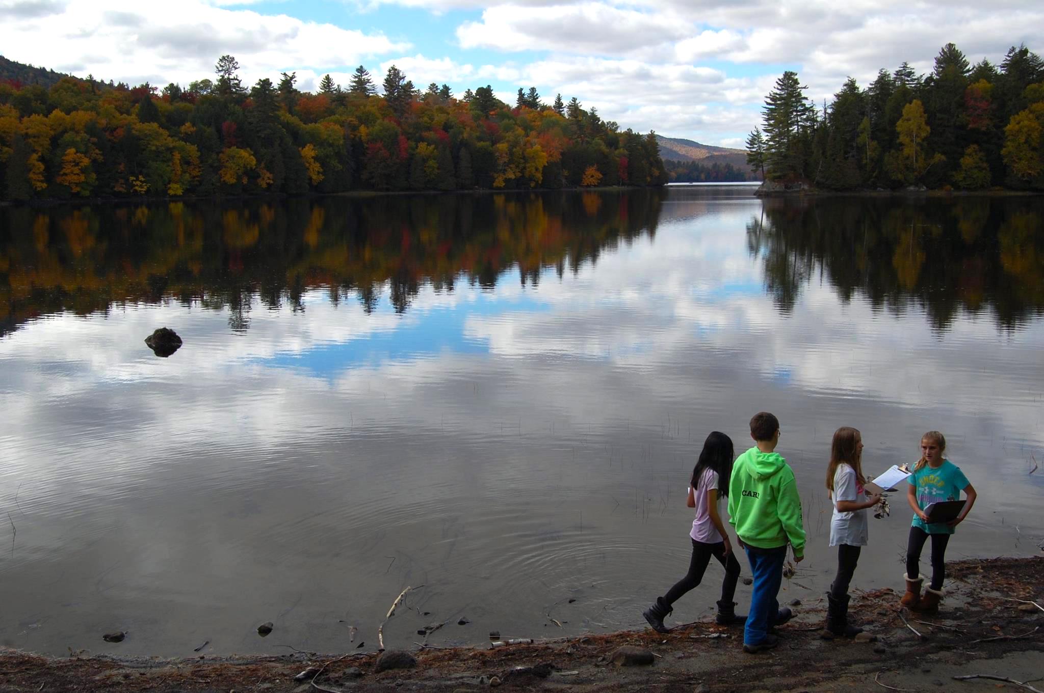 St. Mary's School from Canandaigua hunting for producers, consumers, and decomposers on the shores of Rich Lake