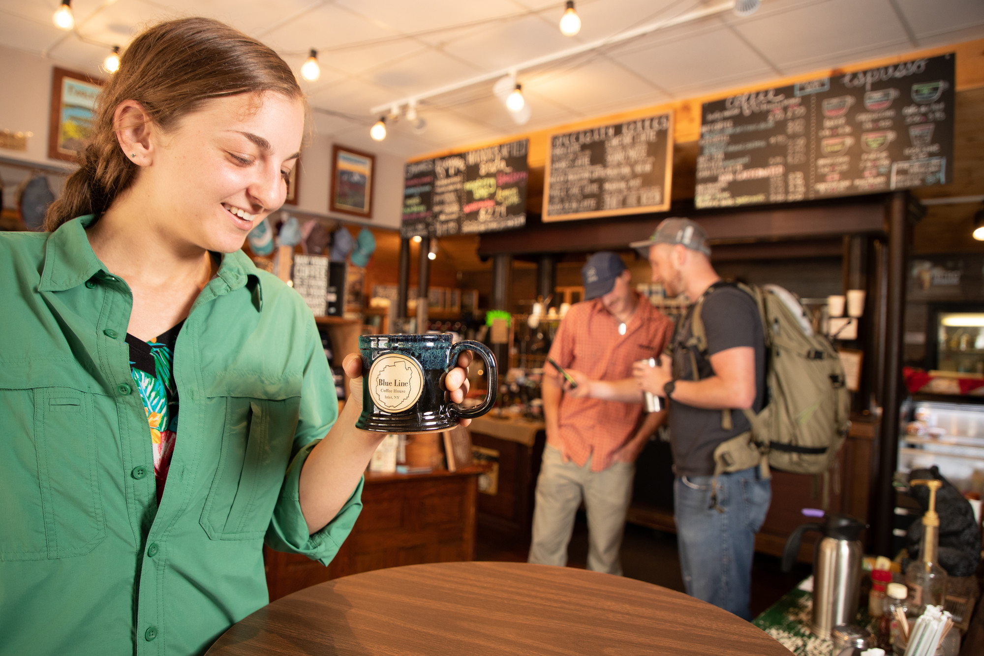 A woman inspects a mug while shopping. 