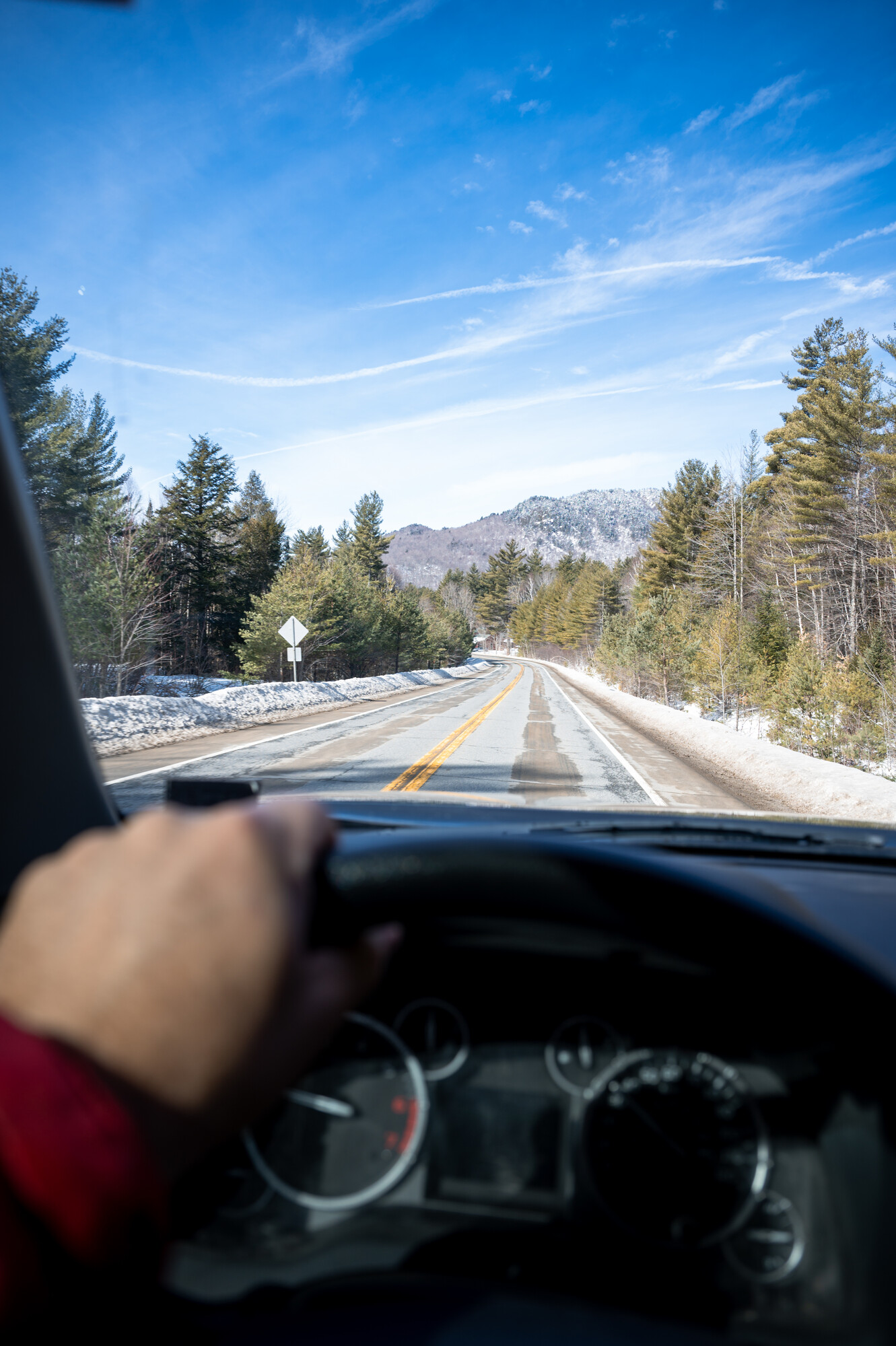picture of gentleman driving with mountains in the back ground