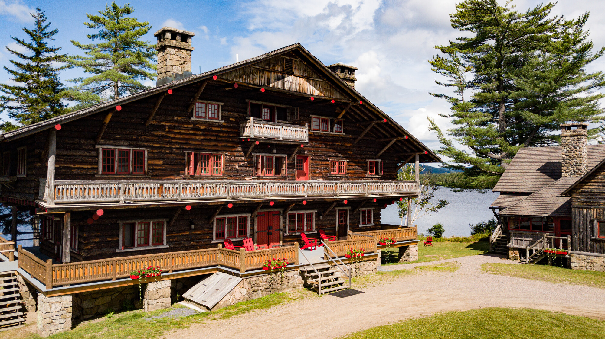 great camp sagamore; log camp with red accents