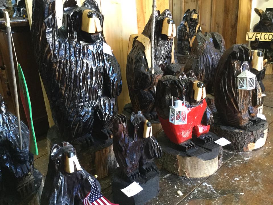 Animals carved from wood in a range of sizes and species.