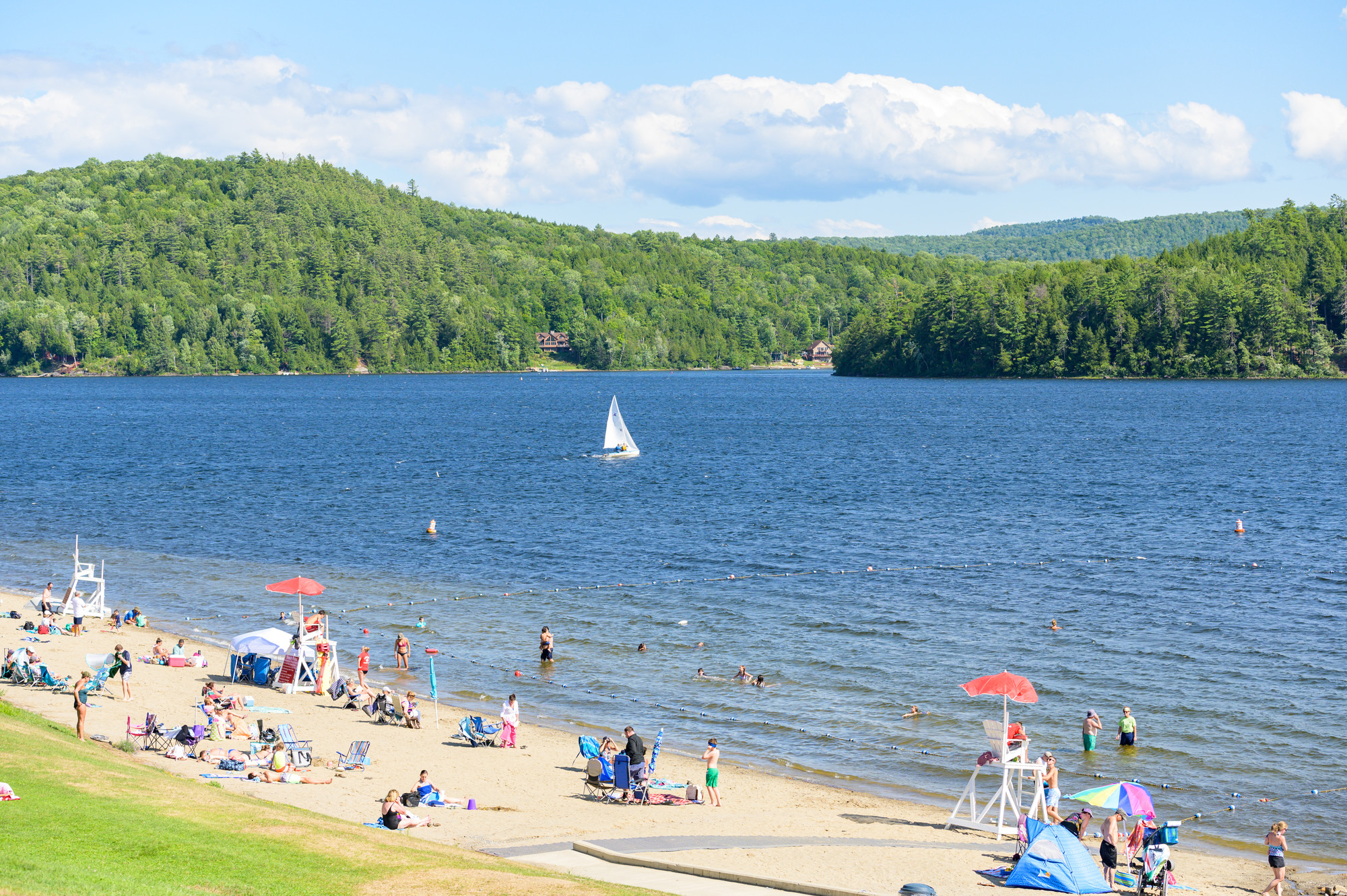 A lakefront beach on a sunny day. 