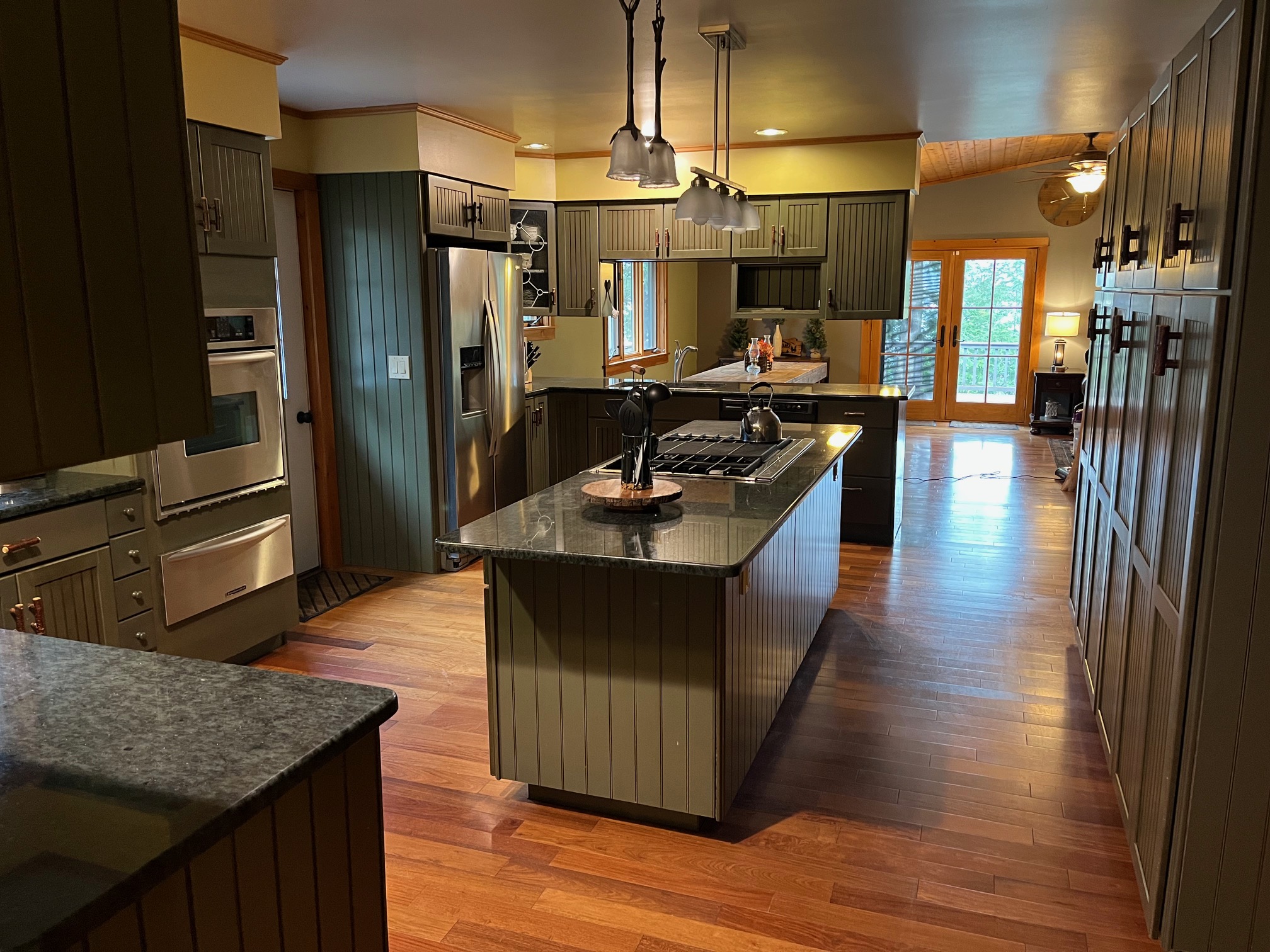 A dark green kitchen in a country-style home.