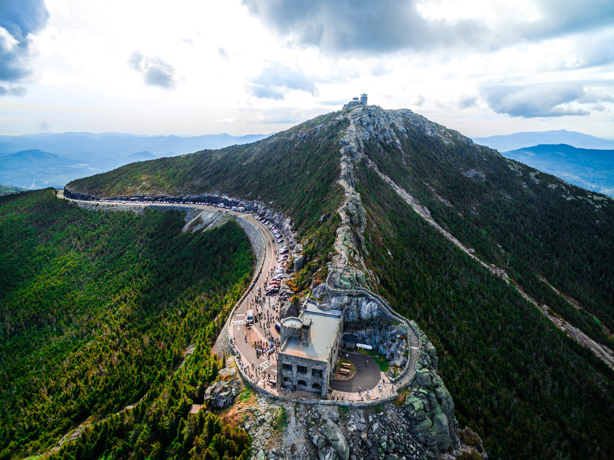 An aerial view of the top of Whiteface Mountain and the highway carved into its side.