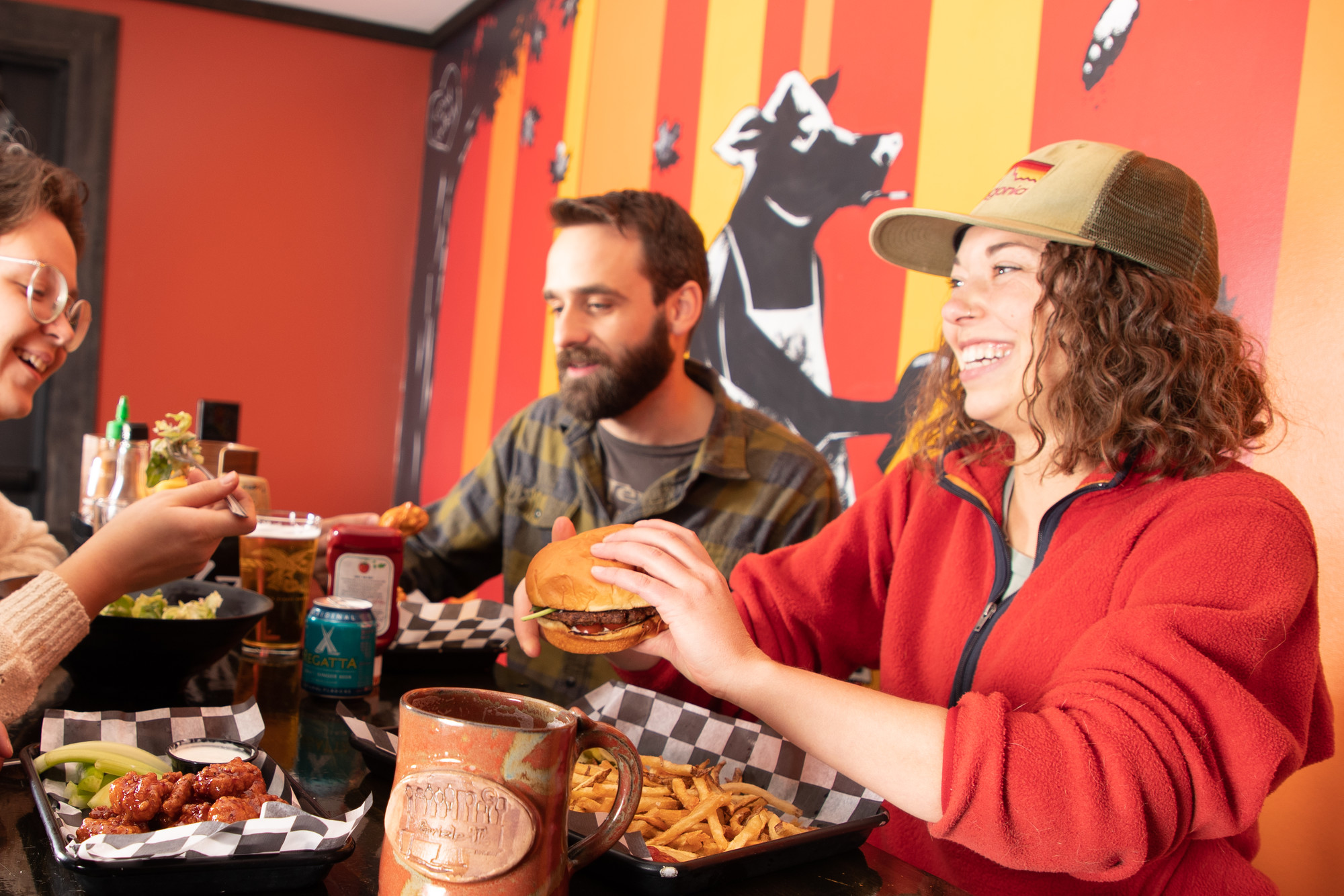 Delicious comfort food is what you can expect this fall at Grizzle's Friends enjoy a meal of wings, beer, burgers, fries, and a salad.