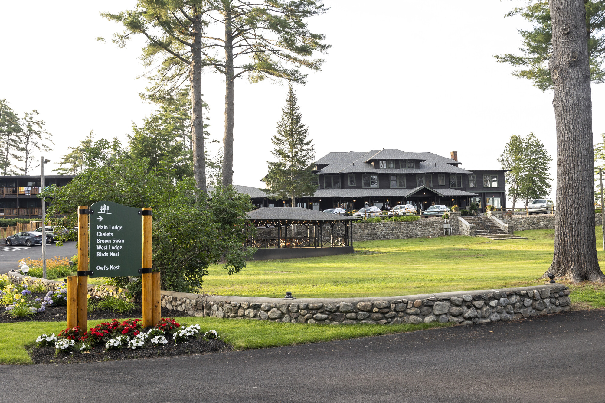 The front grand entrance to a lodge-style hotel.