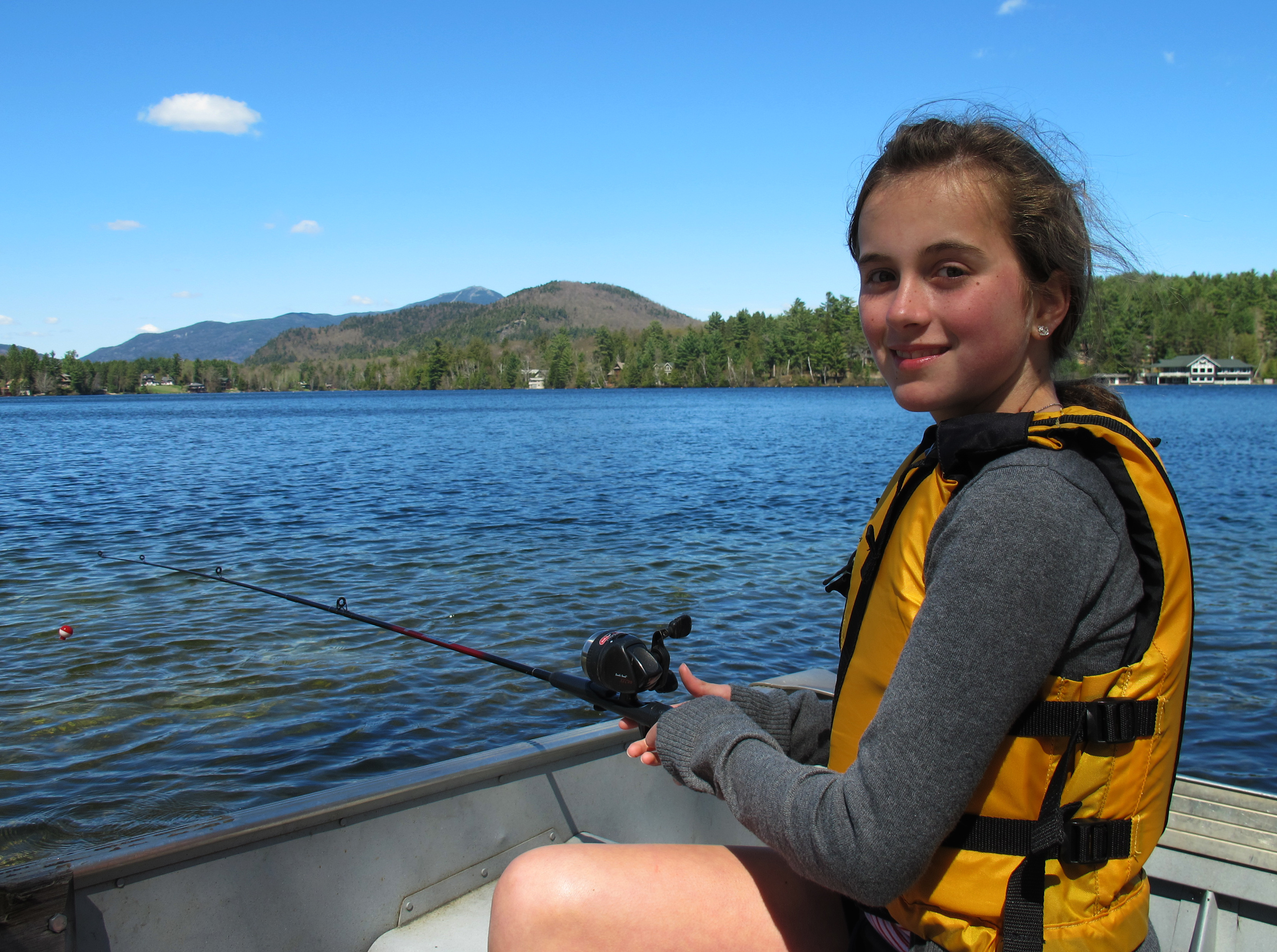 Girls with fishing pole in boat