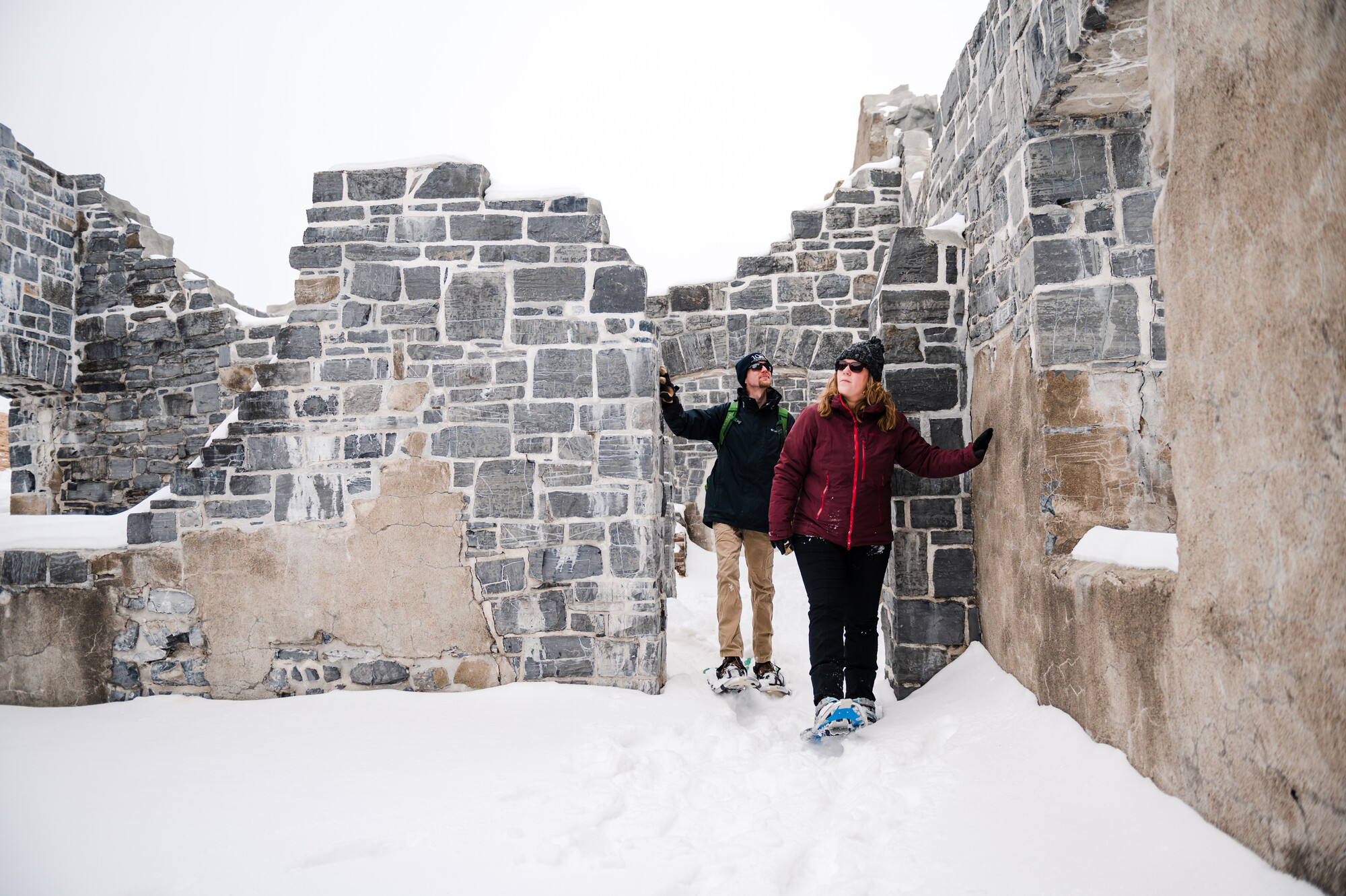 Two people walking the ruins of an old fort