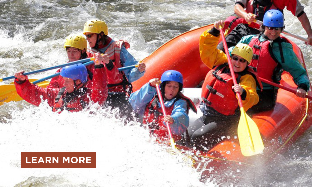 A group getting adventurous whitewater rafting.