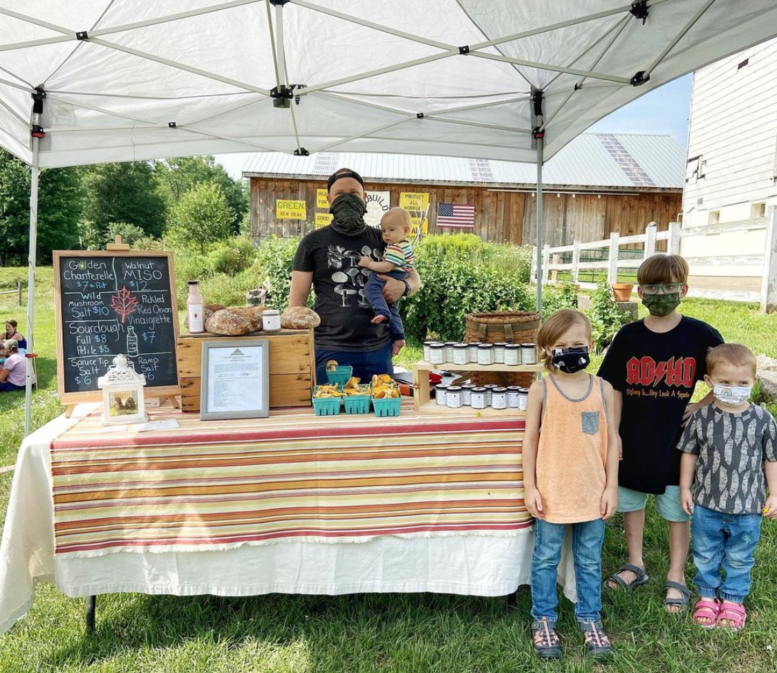 Jordan Sauter stands with his children at his popup shop