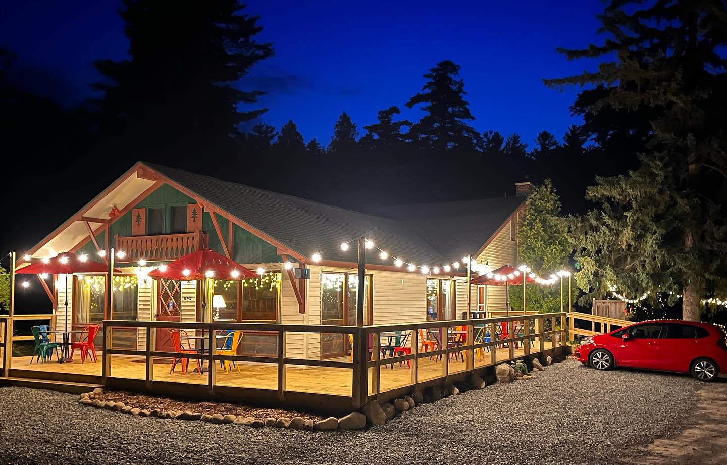 A nighttime view of the ADK Trail Inn's main building