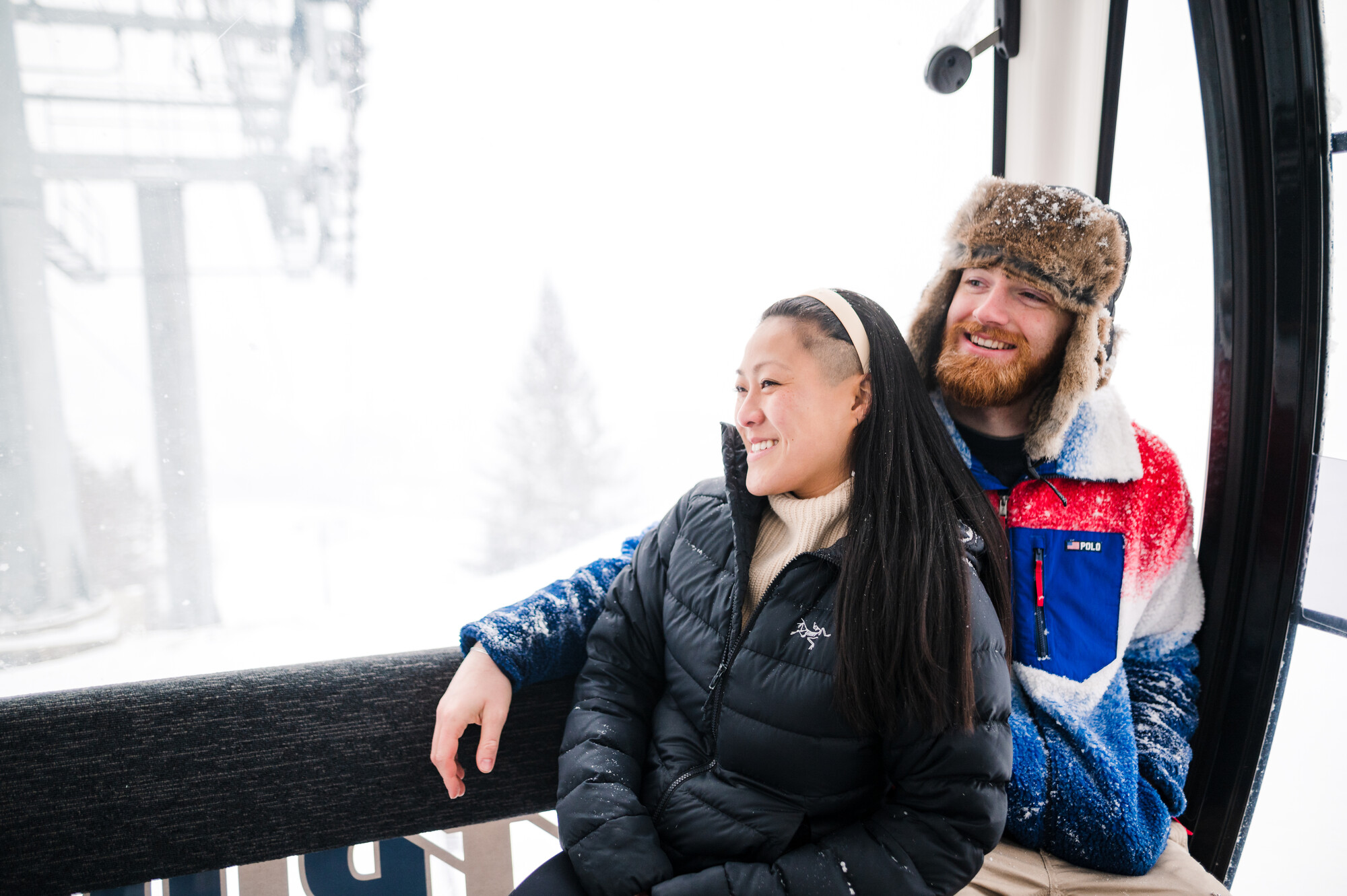 A man and woman sit together on a gondola.