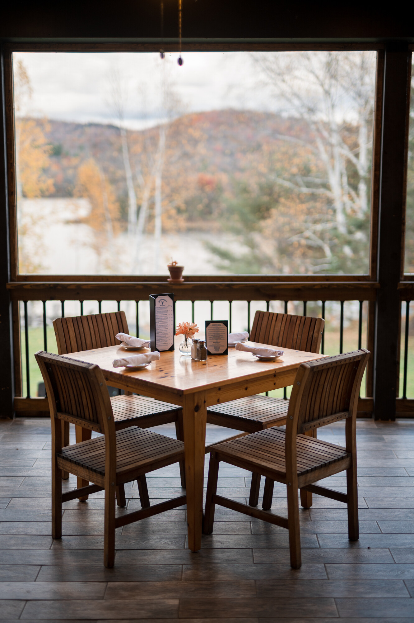 A four-top dining table waits to seat customers on an outdoor patio