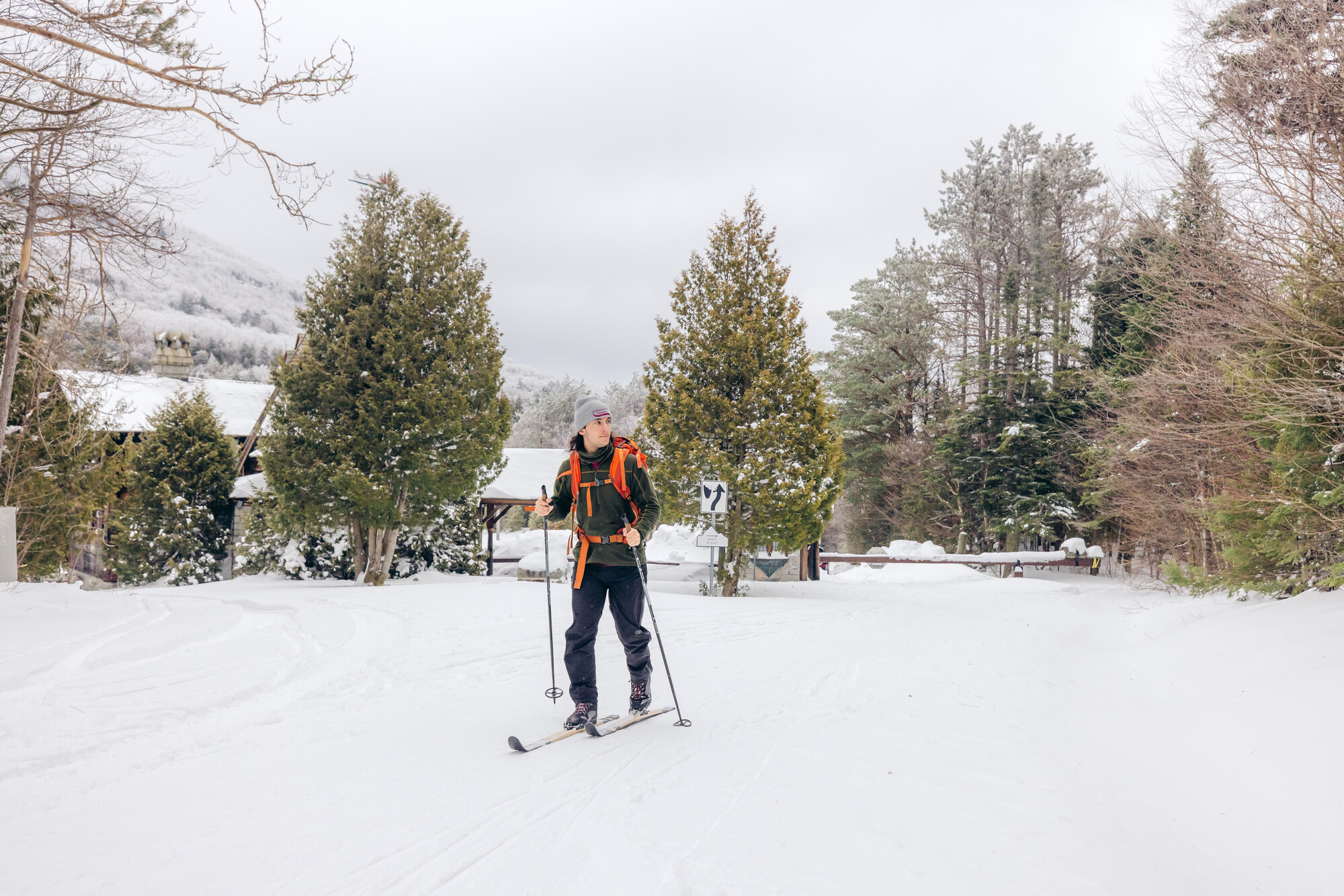 A cross-country skier leaving a toll booth area