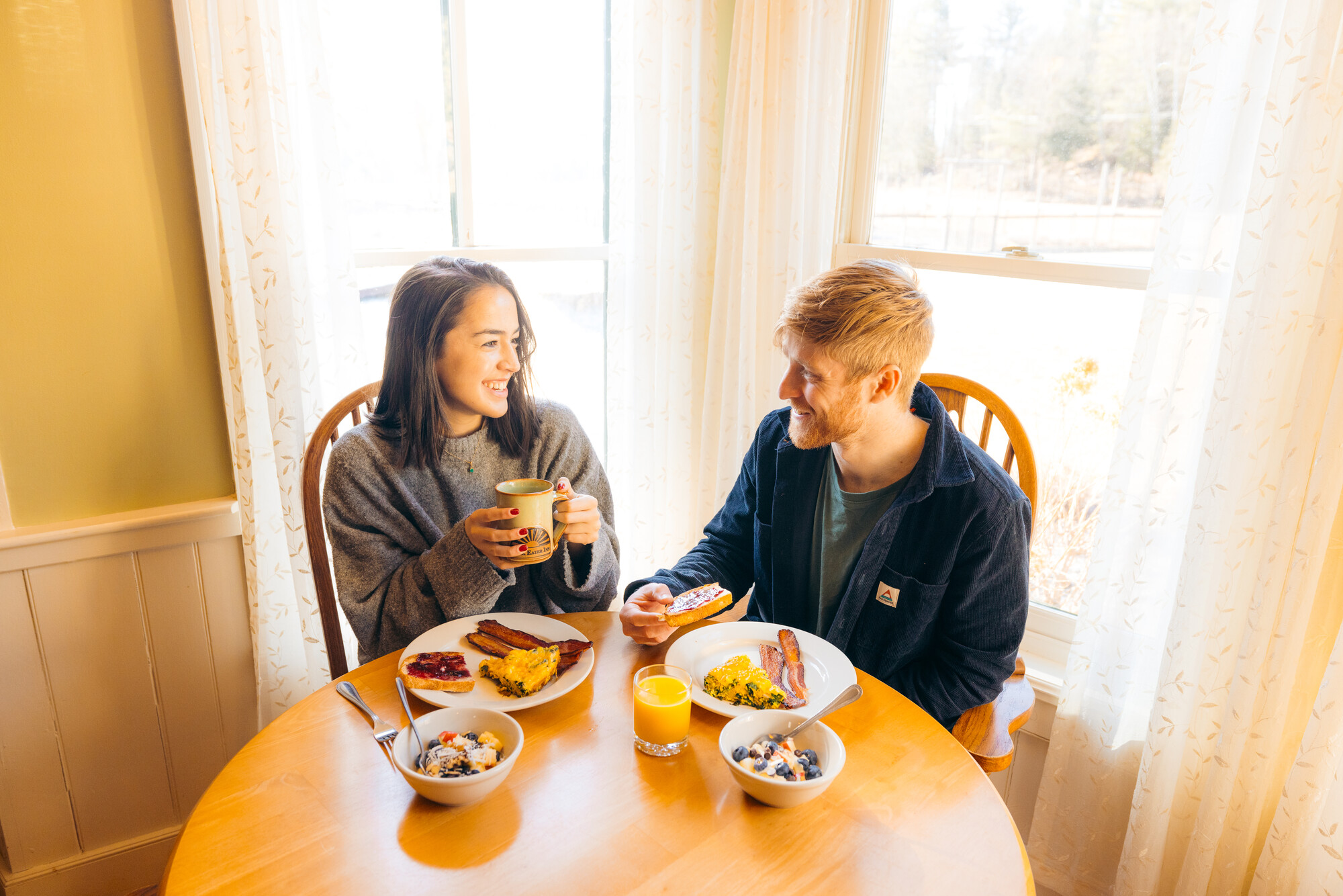 A man and woman share breakfast together. 