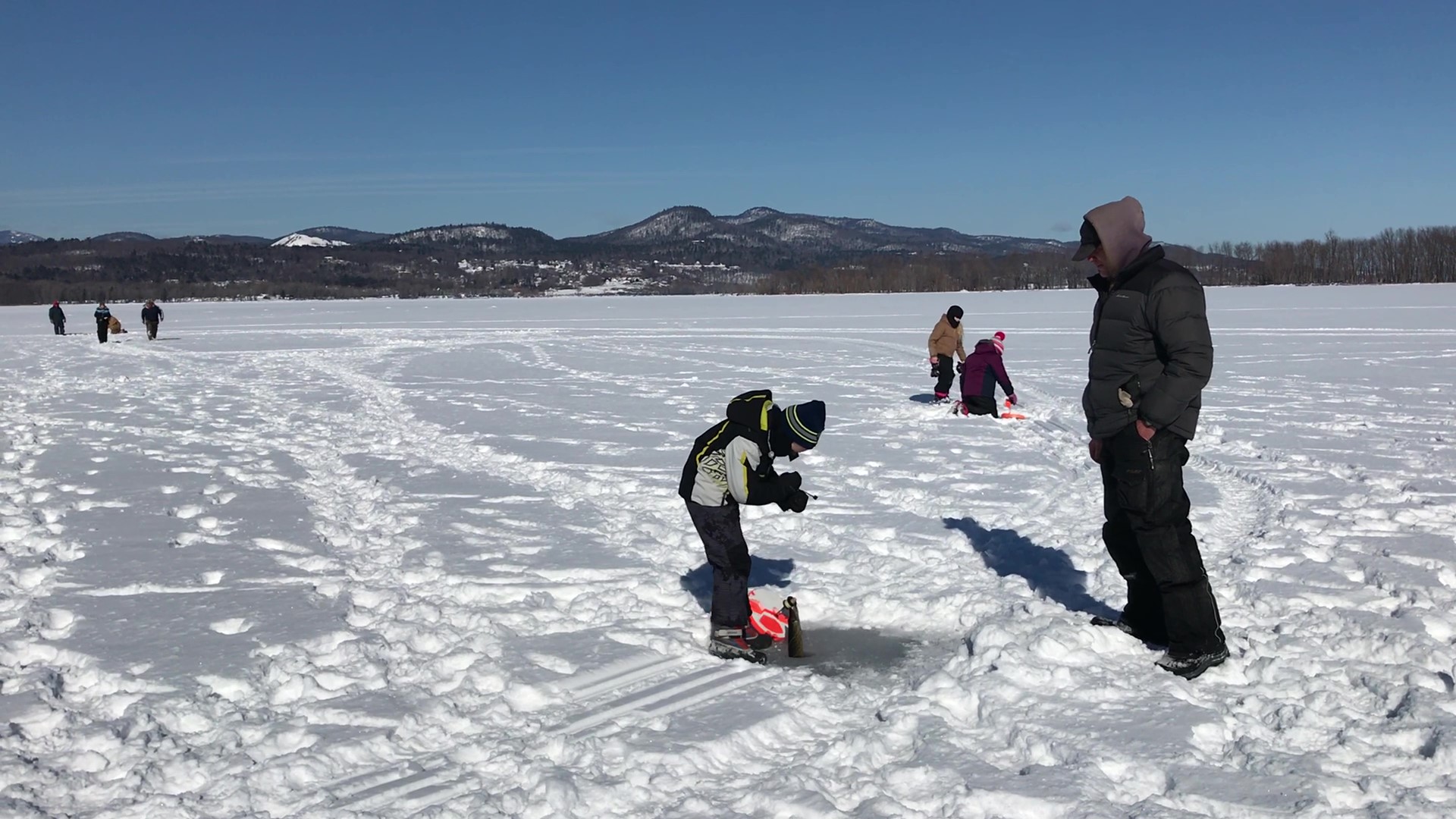 image of a group of people as one at the fishing hole brings up the catch