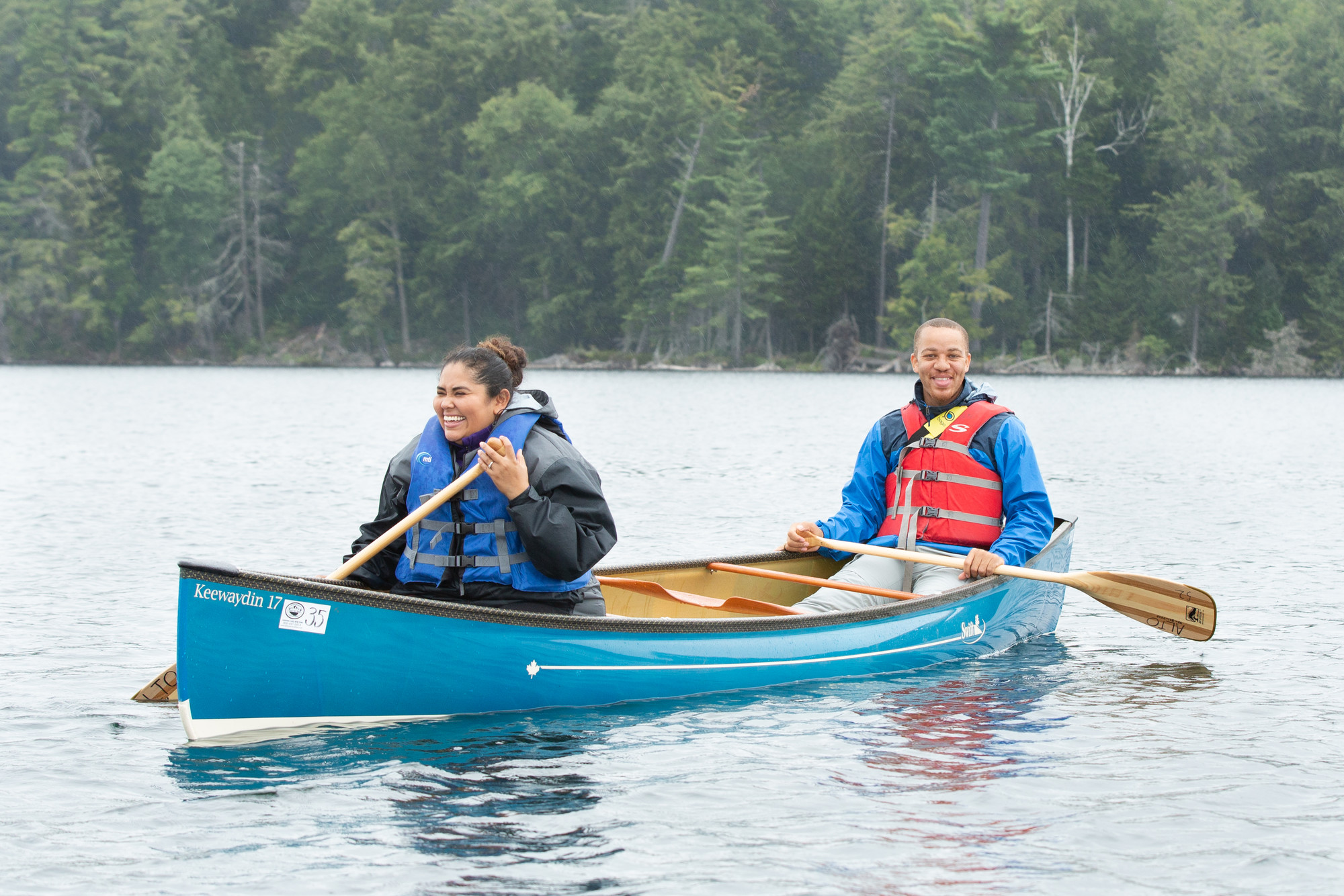 A couple paddles on a lake