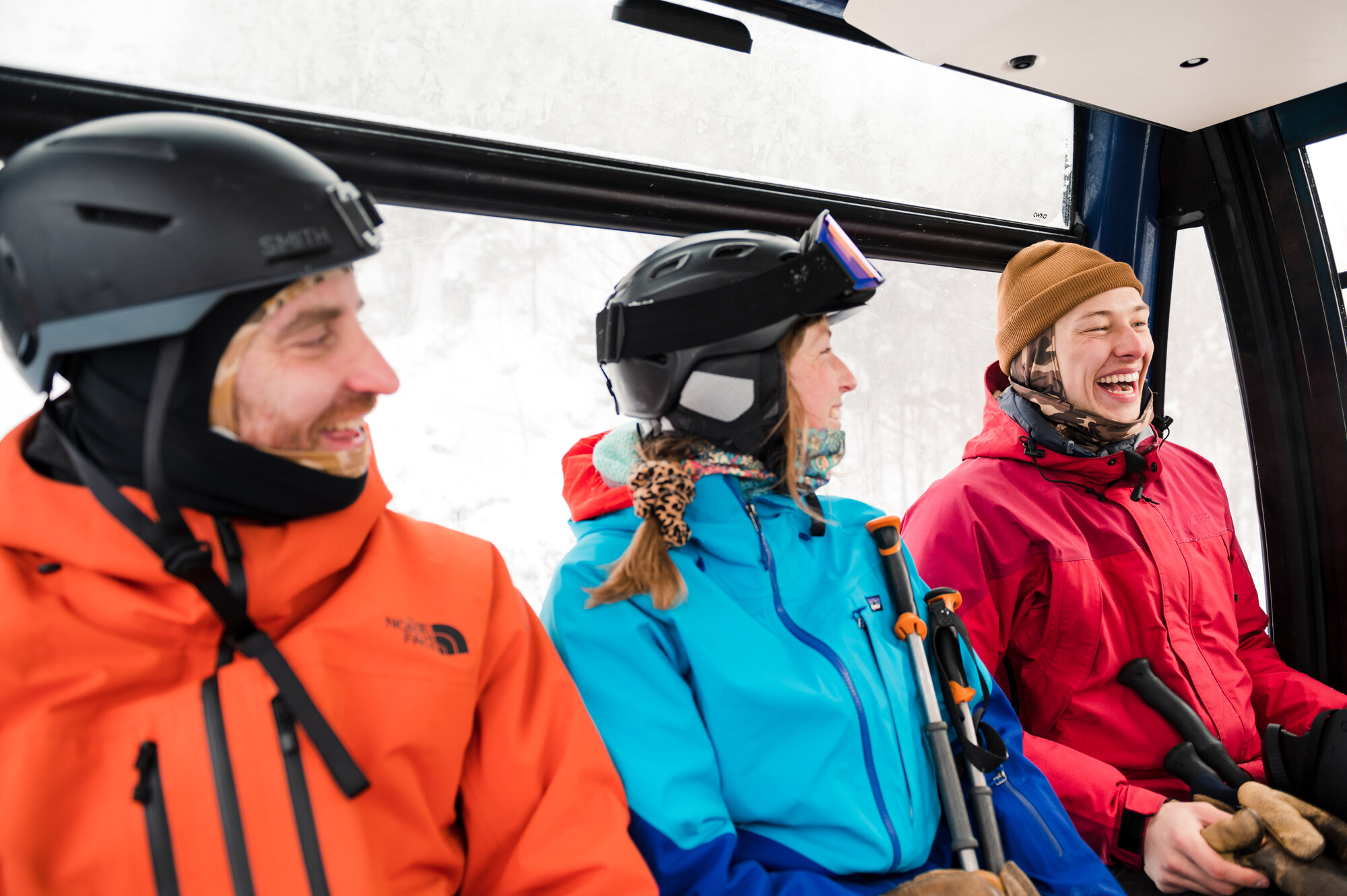 A group of friends on a gondola ride chatting and laughing.