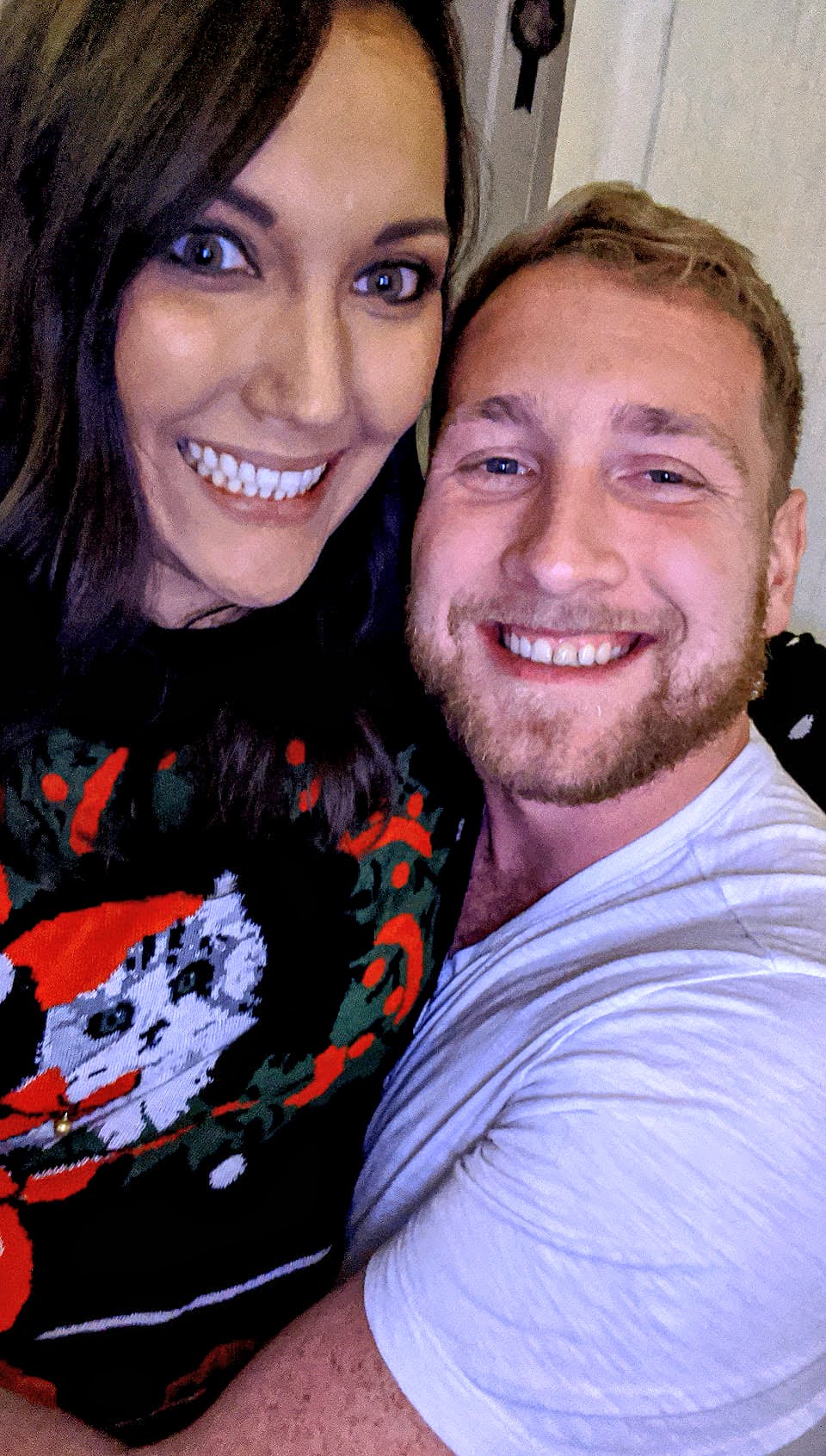 Relaxed, stress-free, and wishing everyone a Happy New Year! Two people smile at the camera