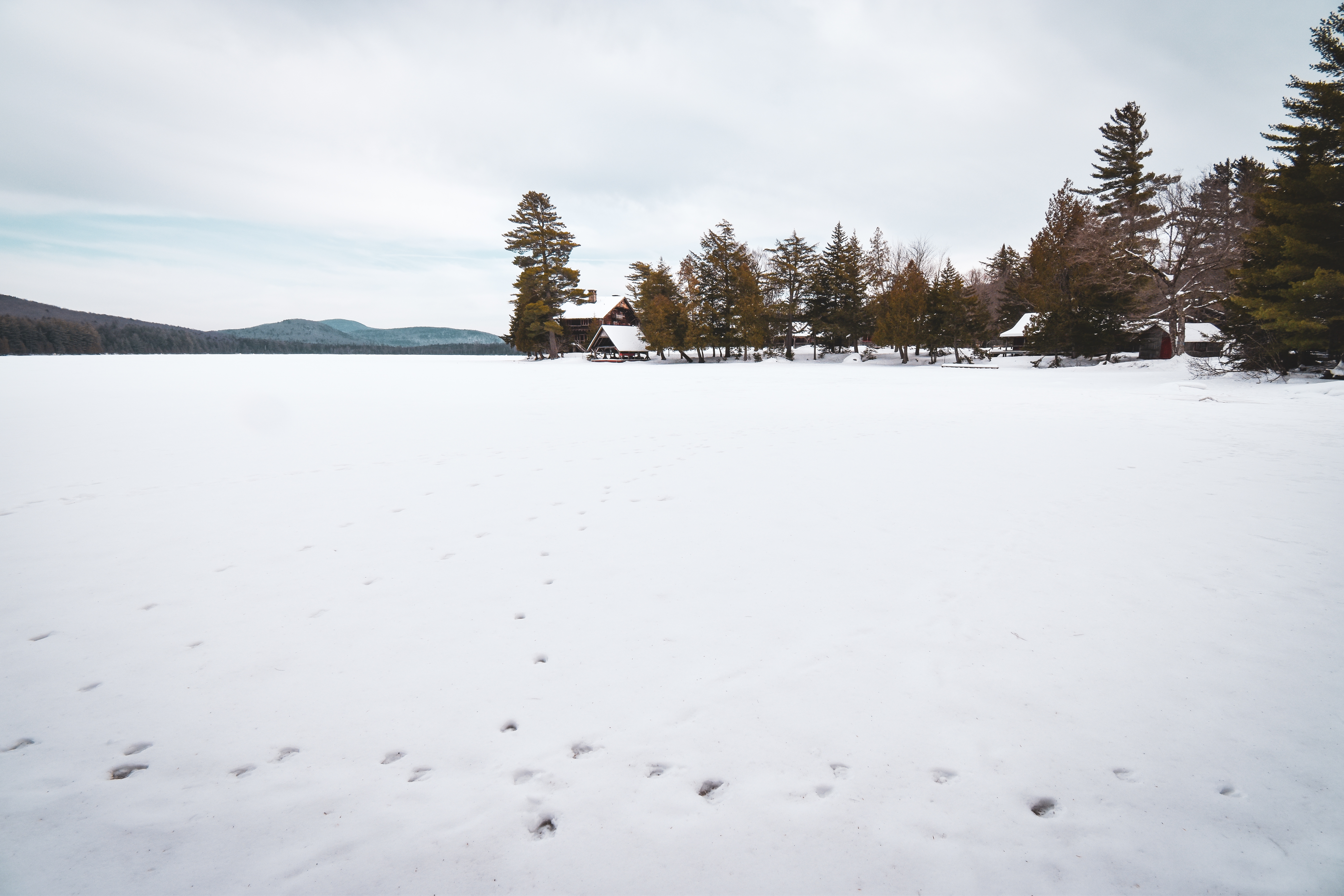 A snowy view of Sagamore Lake and Great Camp Sagamore.